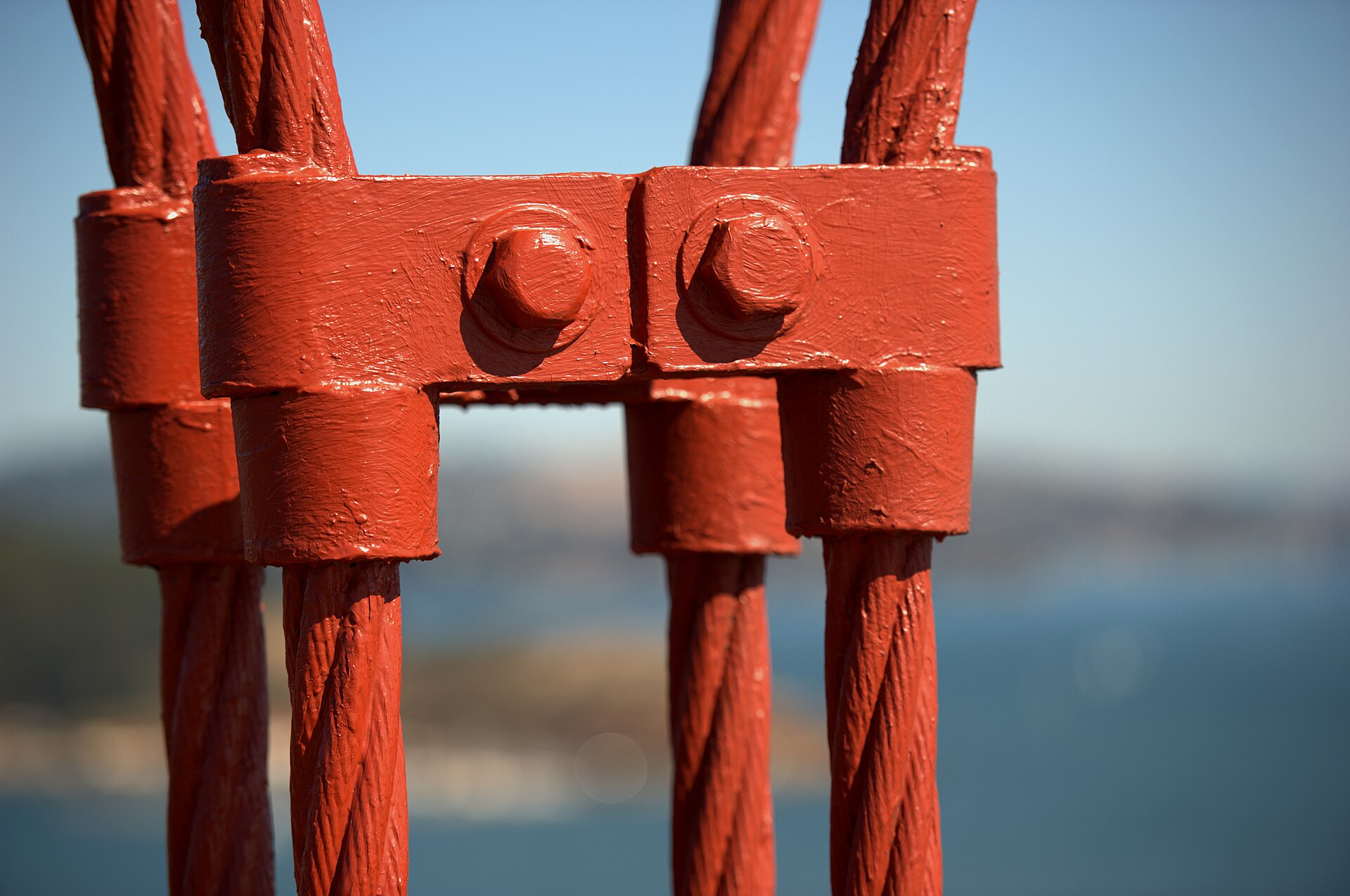 Close view of red bridge cables and steelwork